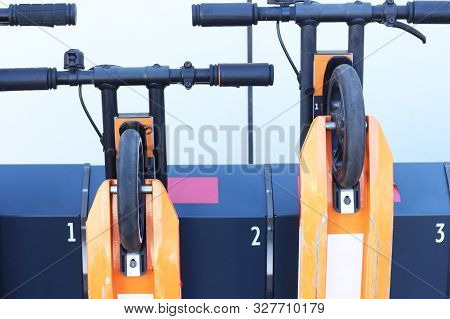 Electric Kick Scooter In Sharing Parking Lot. Scooter Rental Station. New Sharing Business Project.p