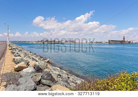 Industrial Export Import Wharf Beside A Recreational Marina And Rock Seawall At An Australian City