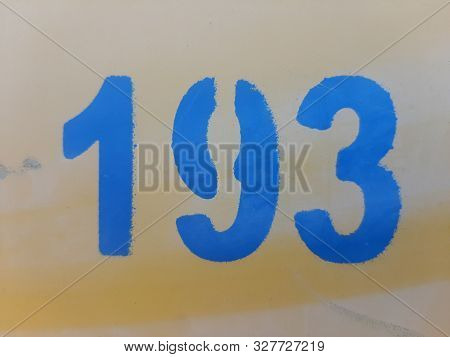 Number One Hundred Ninety Three, The Number Is Printed On The Yellow Wall Using A Stencil, Number 19