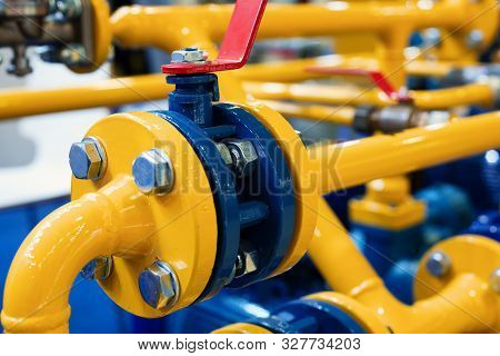 Gas Station. Many Diverse Pipes Connected By Flanges. Flange Bolt Connection. The Pipes Are Painted 