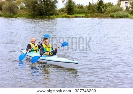 Two Men On A Kayak, Tourists Rafters In A Blue Boat, Matrosovka River, Polessky District, Kaliningra
