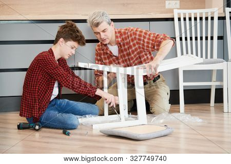 father and son work together. kithen chair assembling