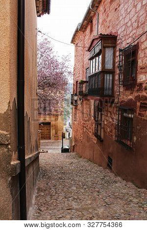 Beautiful Pink Cherry Tree In Bloom Next To San Miguel Arcangel Parish In Alcaraz In Spring. Old And