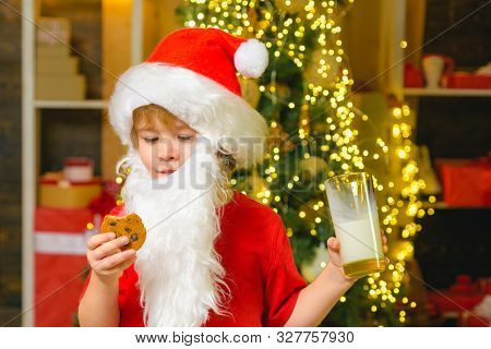 Portrait Of Bearded Funny Child In Santa Costume. Merry Christmas And Happy New Year. Santa Holding 