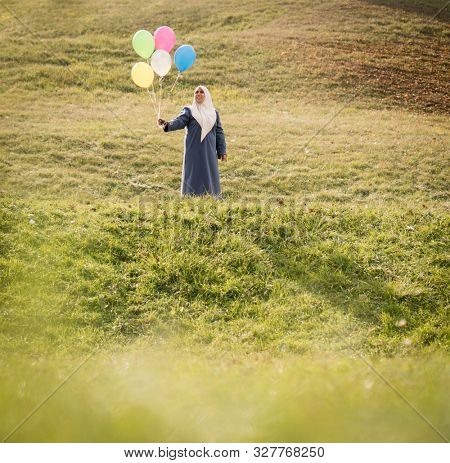 Muslim Arab woman on green meadow