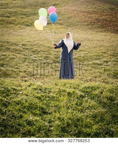 Muslim Arab woman on green meadow