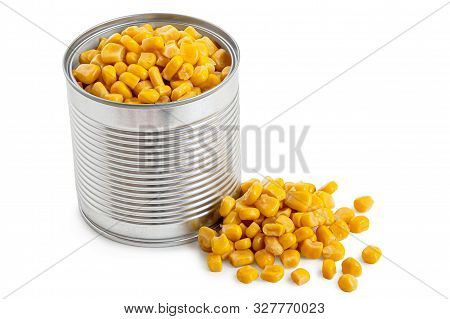 Canned Sweet Corn In An Open Metal Tin Next To Spilled Sweet Corn Isolated On White.