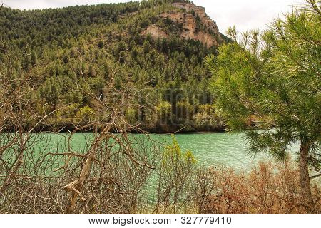 Tolosa Reservoir Surrounded By Vegetation And Mountains In Alcala Del Jucar Village, Albacete, Spain