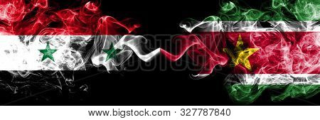 Syria Vs Suriname, Surinamese Smoke Flags Placed Side By Side. Thick Colored Silky Smoke Flags Of Sy