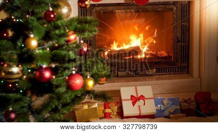 Beautiful Interior With Burning Firepalce, Christmas Tree And Big Stack Of Xmas Gifts