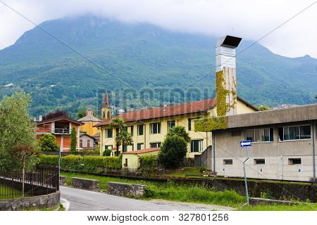 Italian Mandello Del Lario Houses With Alps Mountains In Background.