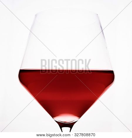 A Glass Of Red Wine Close-up On A Light Background. Minimalism.
