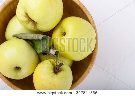 Ripe  Yellow Apples In Wooden Bowl On White Background. Antonovka Apples. Top View, Close-up, Copy S