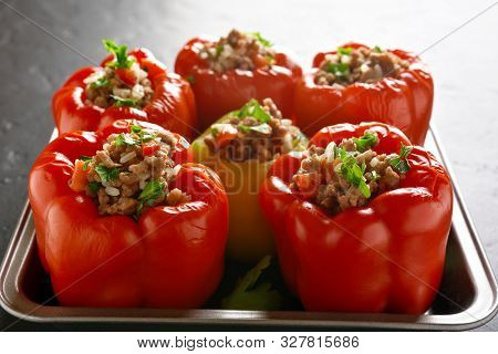 Close Up Of Stuffed Red Peppers With Minced Meat, Rice, Onion In Baking Dish