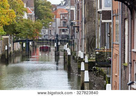 Historic Canal Houses Along The Voorstraathaven With The Bridge Pelserbrug In The Background In Dord