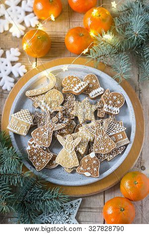 Gingerbread Cookies On A Concrete Tray On A Winter Background With Tangerines, Fir Branches And A Ga