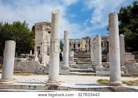 Athens, Greece - April, 2018: Tourists Visiting The Ancient Ruins At The Roman Agora Located To The