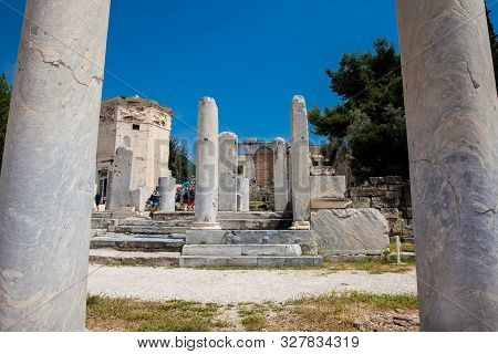 Athens, Greece - April, 2018: Tourists Visiting The Ancient Ruins At The Roman Agora Located To The