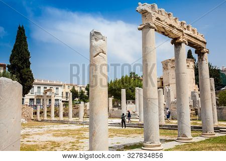 Athens, Greece - April, 2018: Tourists Visiting The Ancient Ruins At The Roman Agora Located To The