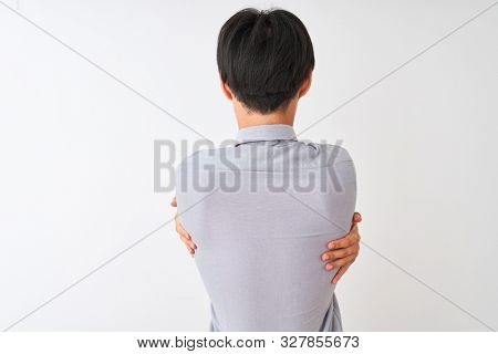 Chinese businessman wearing elegant tie standing over isolated white background Hugging oneself happy and positive from backwards. Self love and self care