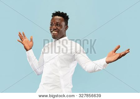 Nice To See You. Young African-american Man Isolated On Blue Studio Background, Facial Expression. B