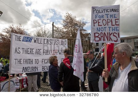 Andrew Duncan fra Exeter Anti-cuts Allience, holder et skilt siger 
