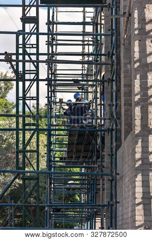 African Construction Workers In Botswana  , Working On A High Building Doing The Structure And The W