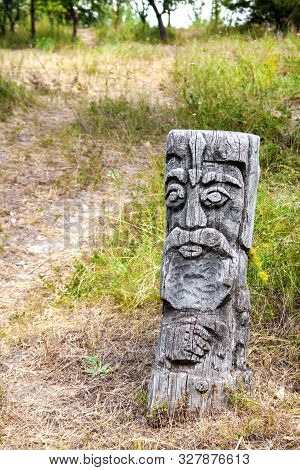 Wooden Idol Of Slavic God By A Path In The Forest