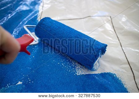 Paint Roller With Blue Paint On Plastic Foil - Preparation Of A Football Choreography By Supporters