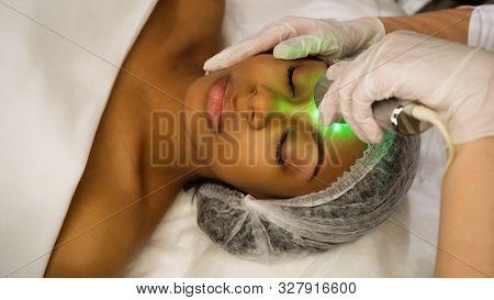Ultrasound Chromotherapy. Hardware Cosmetology. Beautician Carries Out Procedure For Face Skin Rejuv