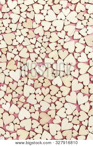 Celebtate Greeting Card With Many Small Wooden Hearts On Pink Paper Surface. Love Concept. Top View 