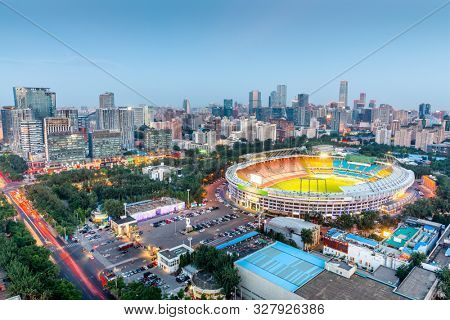Beijing, China skyline and stadium at dusk.