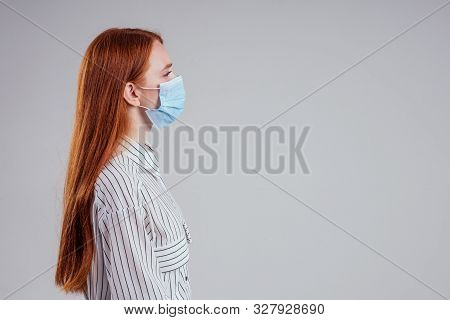 Unhappy Redhead Woman Green Eyes Businesswomen In A Striped Shirt Wearing Gauze Blue Mask White Back