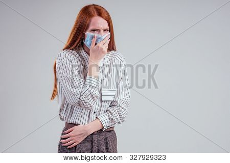 Unhappy Redhead Woman Green Eyes Businesswomen In A Striped Shirt Wearing Gauze Blue Mask White Back