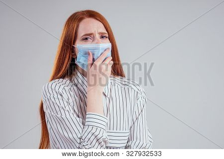 Unhappy Redhead Woman Green Eyes Businesswomen In A Striped Shirt Wearing Gauze Blue Mask White Back