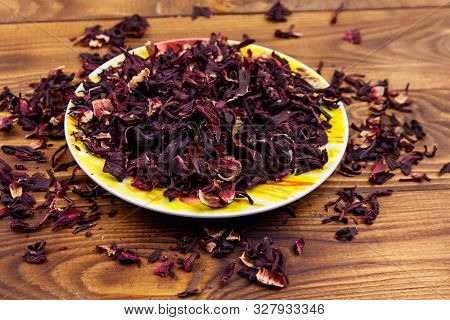 Dried Hibiscus (carcade, Roselle) On Wooden Table
