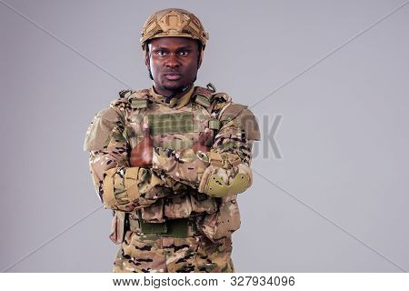 African American Soldier With Folded Arms Standing In White Studio
