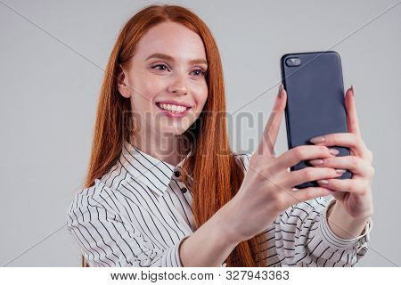 Cheerful Redheared Woman Businesswomen In A Striped Shirt Taking Picture Selfie Photos On Camera Sma