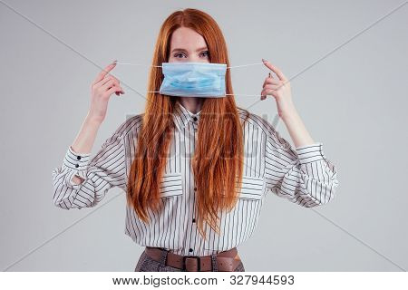 Unhappy Redhead Woman Green Eyes Businesswomen In A Striped Shirt Wearing Gauze Blue Mask White Back