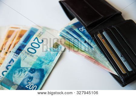 Israeli New Sheqel And Wallet On White Background .