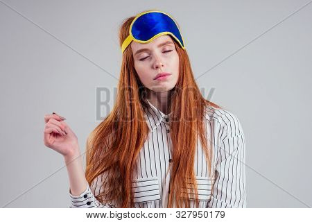 Good Morning. Smiling Redhead Young Business Woman In A Striped Shirt And Blue Yellow Sleep Mask Whi