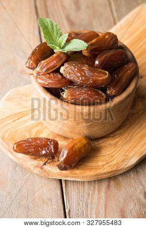 Dates Or Dattes Palm Fruit In Wooden Bowl Is Snack Healthy. Dates In Bowl