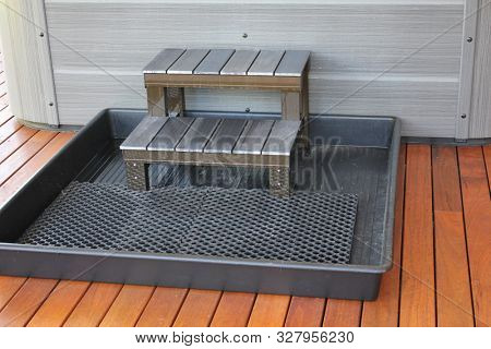 Steps to outdoor hot tub on timber decking with tray