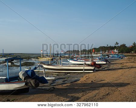 Denpasar, Indonesia - August 22, 2019: Jukung Boats Anchored On The Sand Beach. Jukung Is A Small Wo