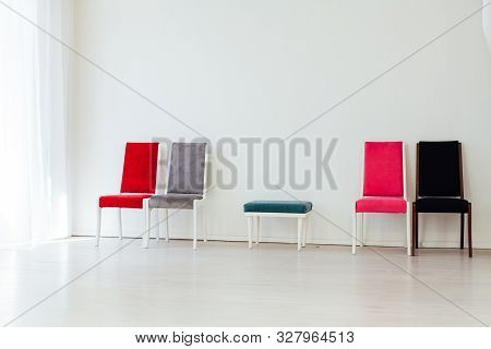 Lots Of Chairs Of Different Colors In The Interior Of The White Room
