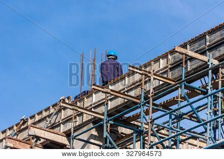 African construction workers in Botswana  , working on a high building doing the structure and the walls