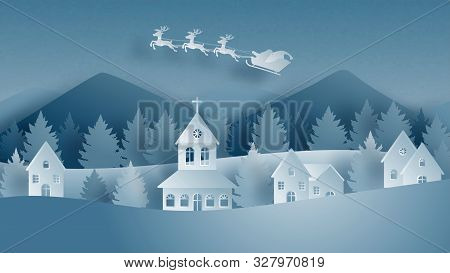 Winter Landscape With Santa Claus On Sleigh And Reindeer Flying Over Village On Snowfield In Paper C