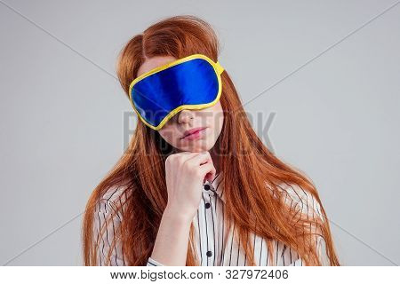 Good Morning. Smiling Redhead Young Business Woman In A Striped Shirt And Blue Yellow Sleep Mask Whi