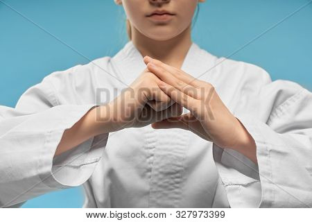 Selective Focus Of Little Hands Of Girl Showing Fist. Hands Position Of Karate. Cute Female Child In