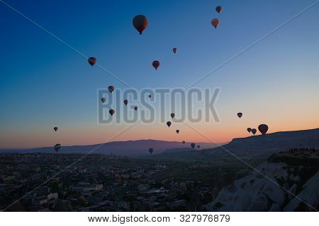 Sunrise Panoramic View To Goreme City And Flying Balloons Over Pigeon Valley Cappadocia, Turkey